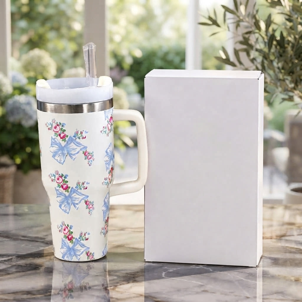 Front display of the Range Studio Hydros Silhouette in Alabaster Cream featuring light blue coquette ribbon bows and tiny pink rosebud bouquets next to a clean white product box.
