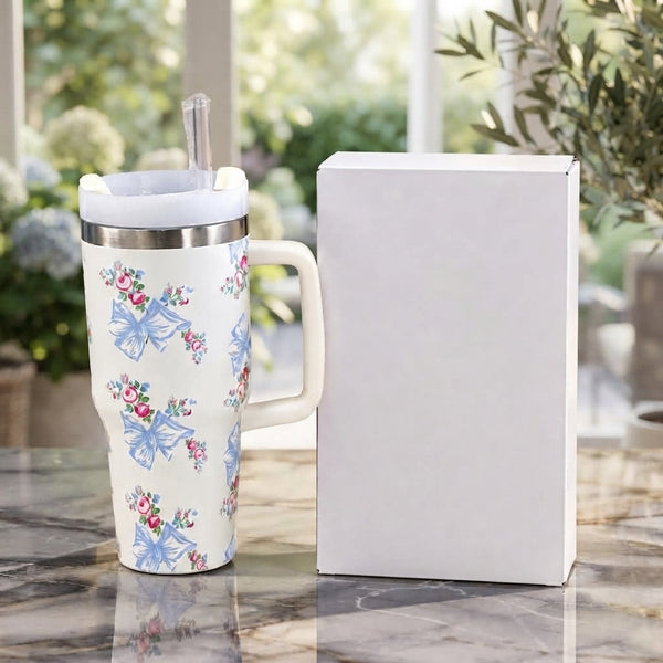 Front display of the Range Studio Hydros Silhouette in Alabaster Cream featuring light blue coquette ribbon bows and tiny pink rosebud bouquets next to a clean white product box.
