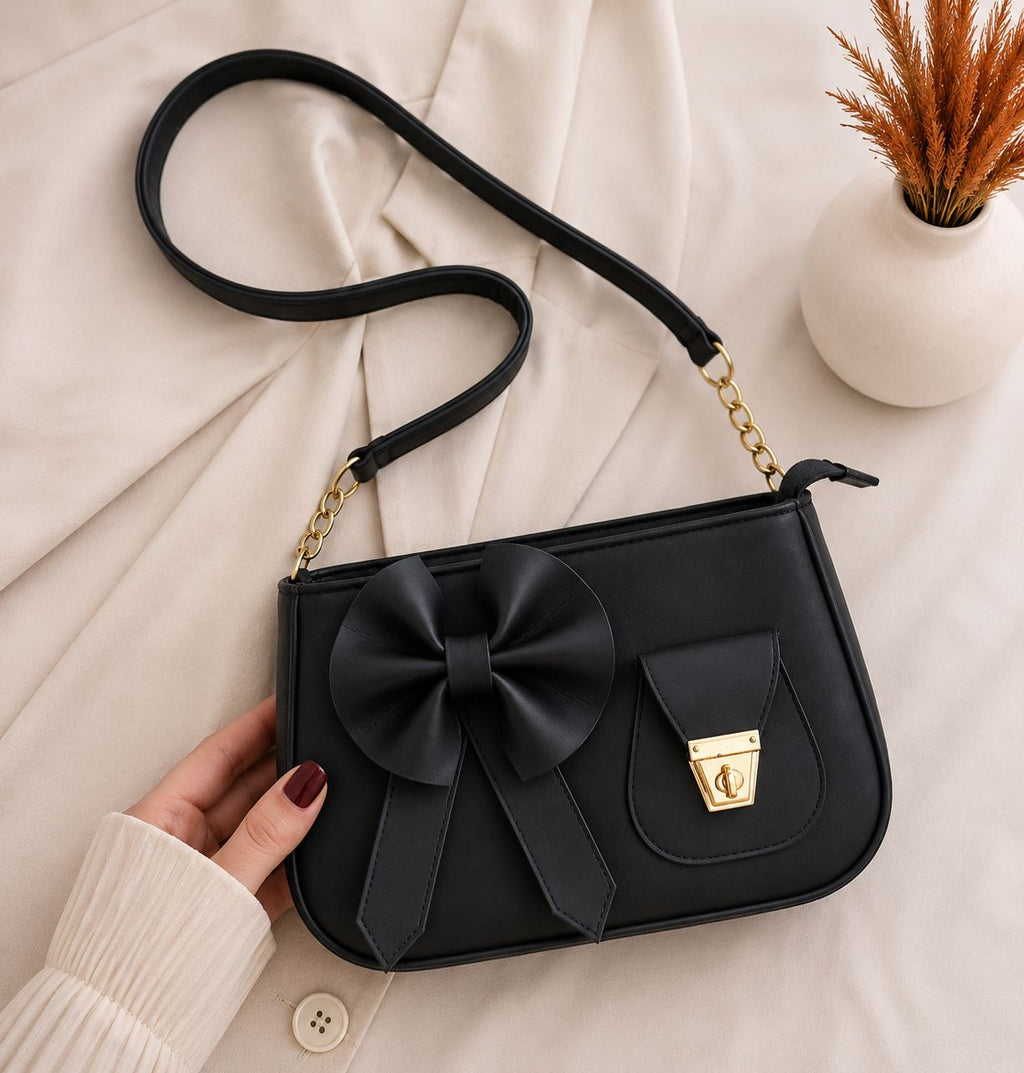 Sleek charcoal black minimalist bow shoulder accessory showing a structured profile tailored for contemporary wardrobes.