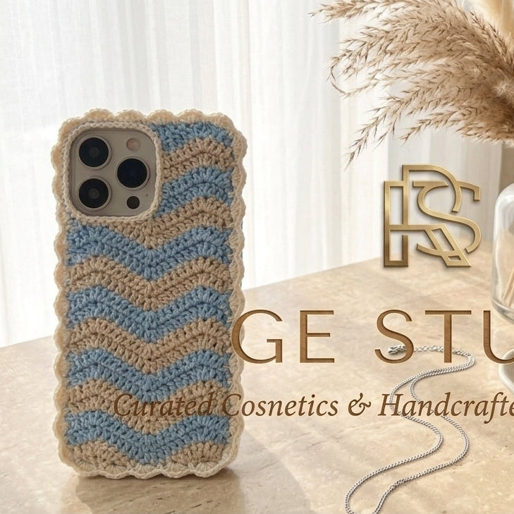 Artisanal crochet phone sleeve in classic blue highlighting a unique statement bow design and detailed yarn patterns.