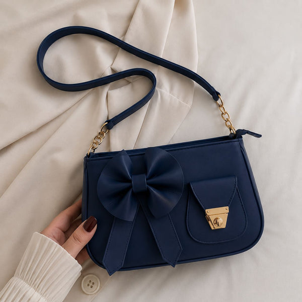Elegant monochromatic deep navy blue version of the trend in aesthetics shoulder silhouette displaying its clean lines and fine stitching.