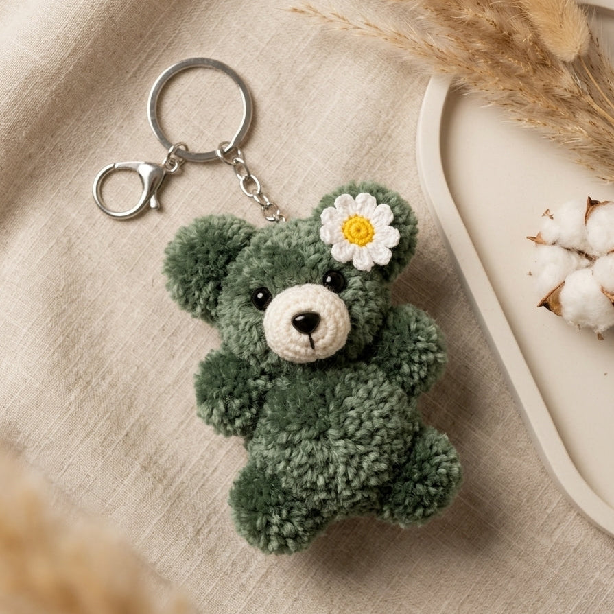Premium woven forest green plush charm detailing a unique hand-shaped silhouette and sturdy metallic clip.