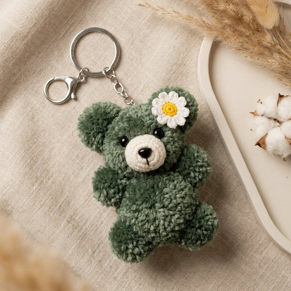 Premium woven forest green plush charm detailing a unique hand-shaped silhouette and sturdy metallic clip.