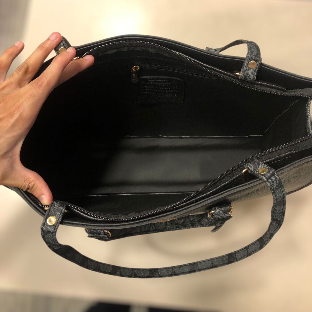 Top view highlighting the spacious inner cabin layout and secure zipped wall compartment of the black Range Studio Accordion Carryall.
