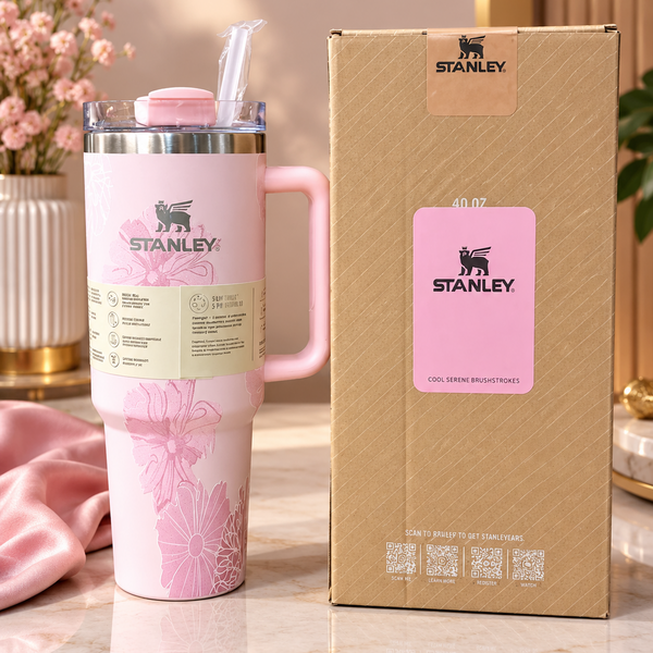 Front display of the Range Studio Hydros Silhouette in soft tea pink with a detailed fuchsia floral pattern resting next to its premium cardboard packaging box on a white marble table.