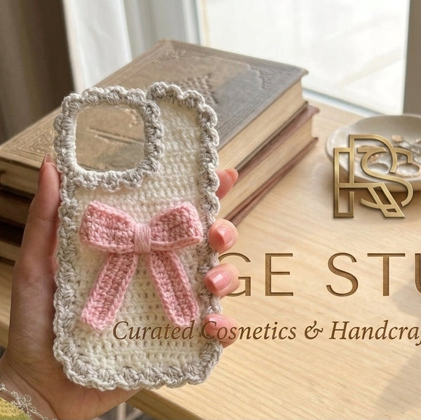 Front showcase of the Range Studio artisanal knit phone case in soft white featuring an intricate hand-woven texture and minimalist aesthetic accents.