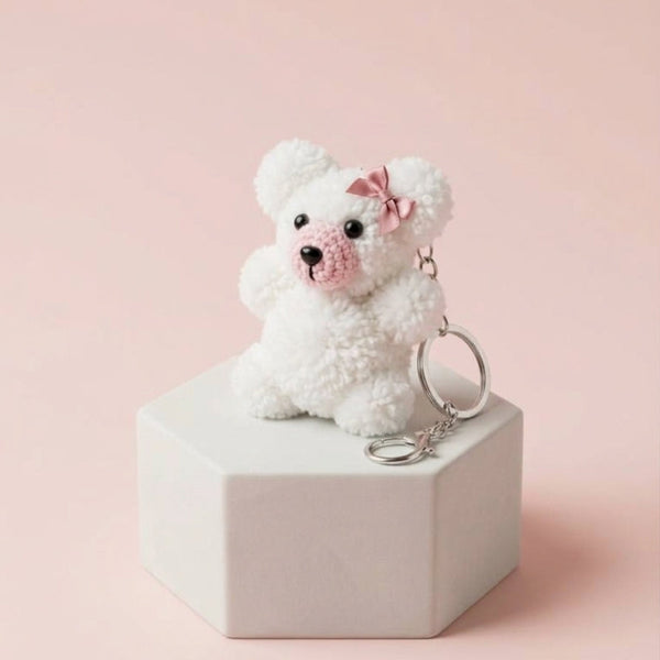 Aesthetic soft white knitted teddy pom charm showcasing intricate custom statement bows and dainty star motifs.