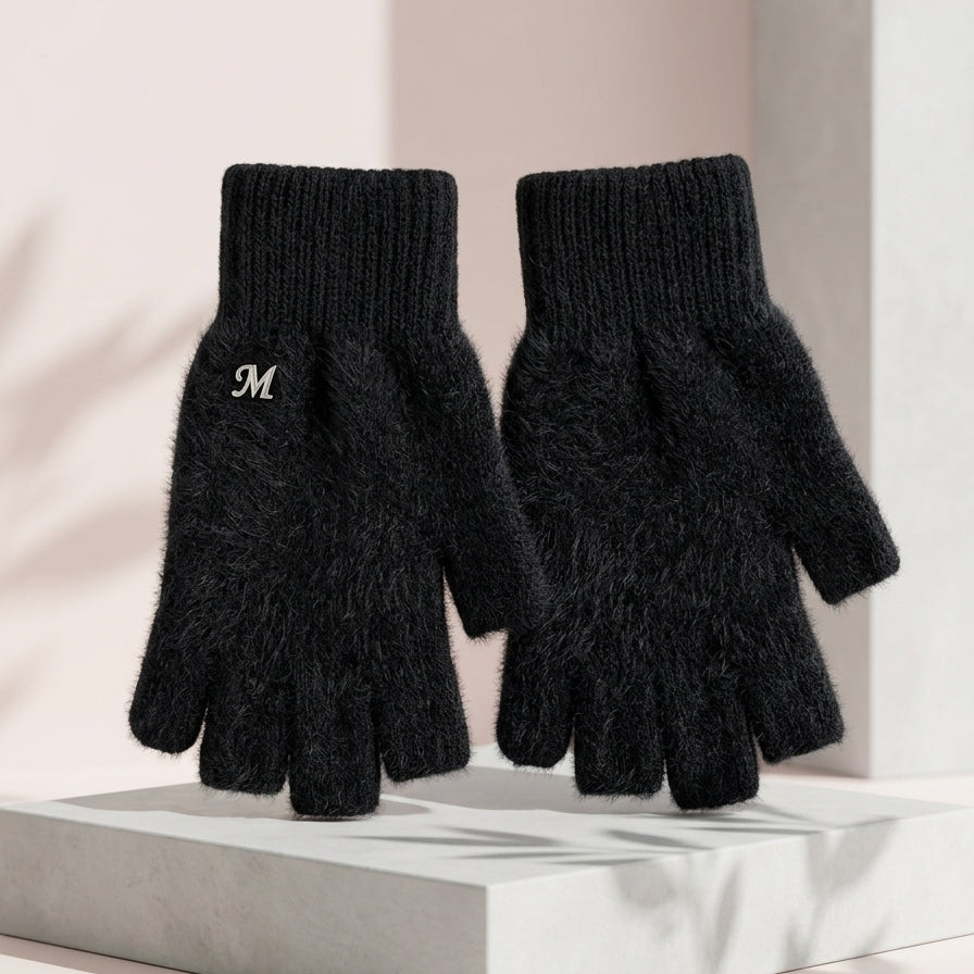 Front profile of the Onyx Black variant thick knit plush rabbit wool fingerless gloves from Range Studio shown on a geometric stone pillar