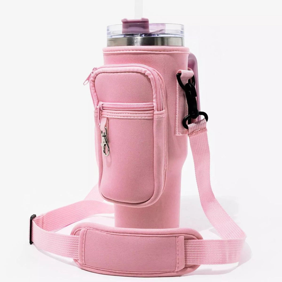 Side profile view of the Blush Tea Pink Range Studio insulated tumbler carrier sleeve showing the zipper utility pocket and adjustable shoulder strap attached to a travel mug .