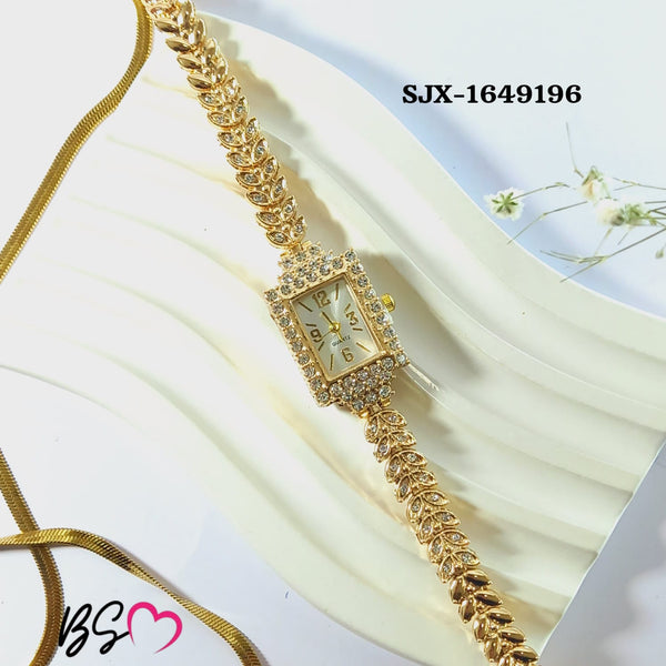 The Imperial Gold version Range Studio rectangular rhinestone watch arranged elegantly next to a delicate white flower accessory.