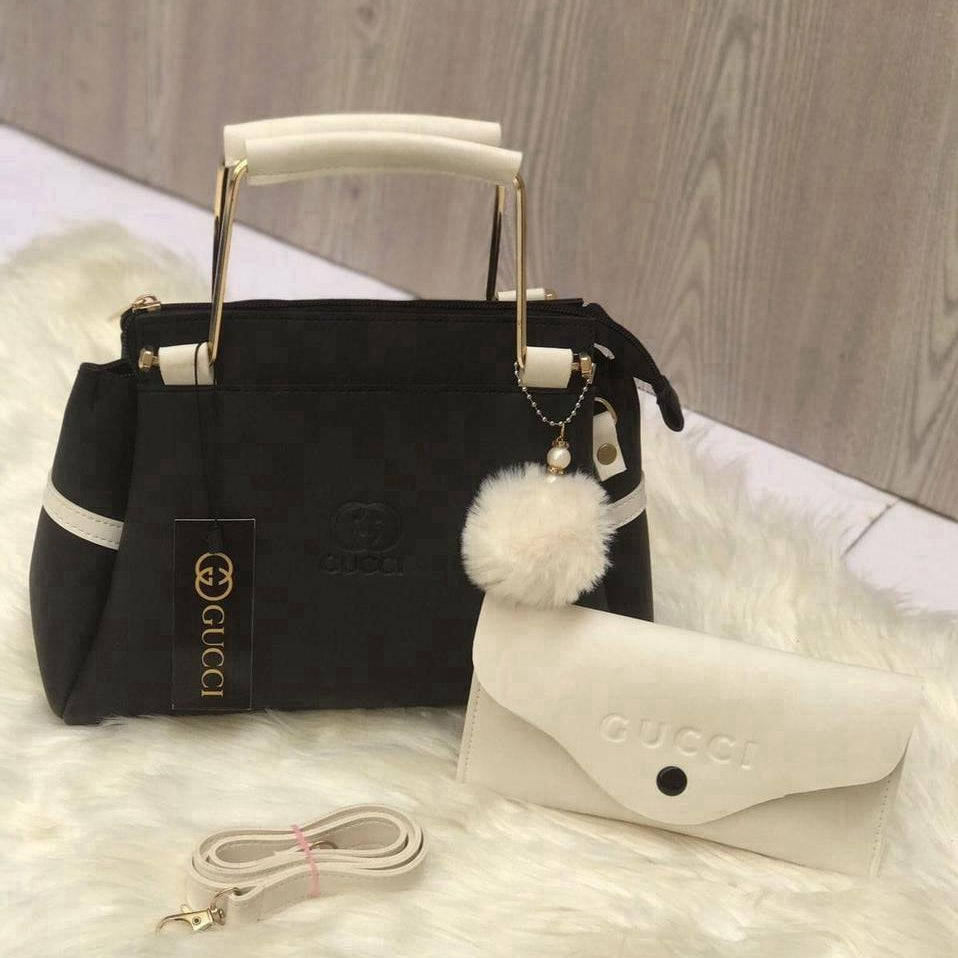 Front showcase of the Range Studio premium black and white contrast top-handle fashion accessory with a structured silhouette and matching mini pouch. Main image