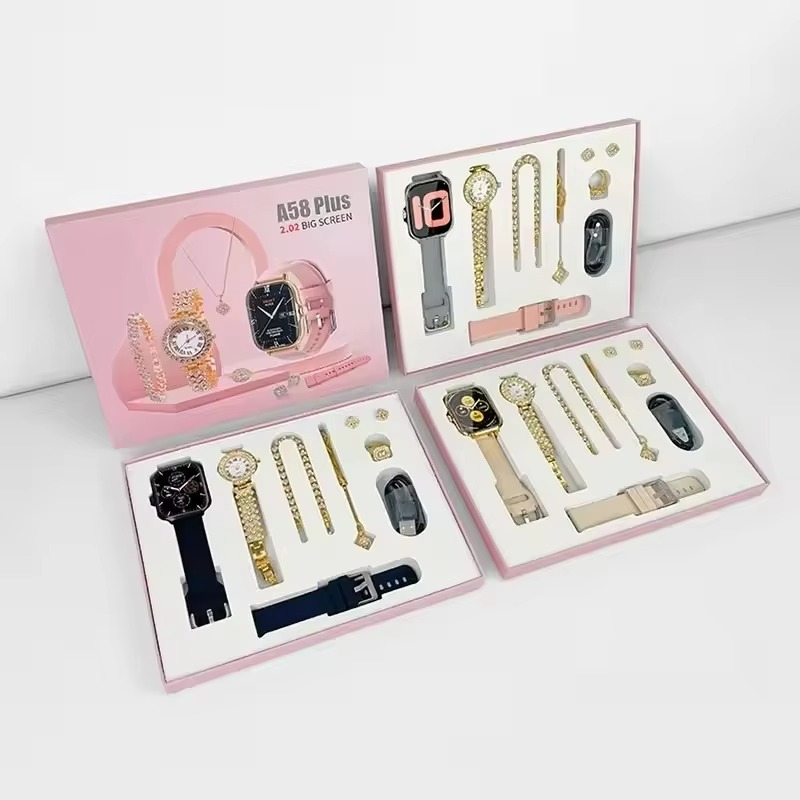 Flatlay component layout of the Alabaster Beige Range Studio smart watch set alongside gold bracelets, necklace, ring, and custom charger cables.