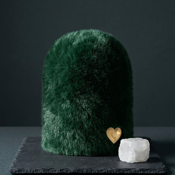 The Emerald Velvet dark green variant of the Range Studio structural plush rabbit wool beanie presented on a dark slate plaque.