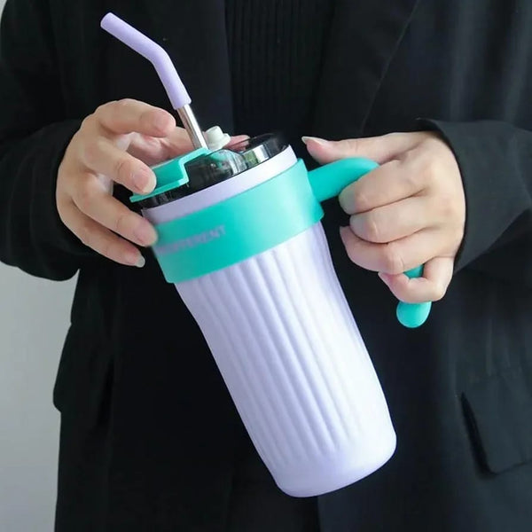 Close-up view of a woman holding the Alabaster White and Blush Pink variants of the Range Studio Ribbed Travel Tumbler with soft-tip straws.