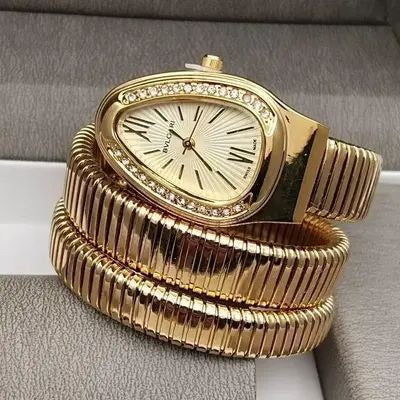 The Imperial Gold version Range Studio Serpentine watch arranged elegantly inside a textured gray leather jewelry presentation box.