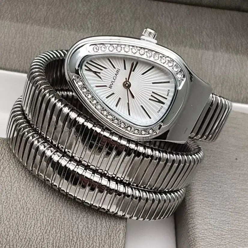 Studio catalog display of the Classic Silver Range Studio snake wrap watch with clean white backgrounds showing off the pink crown stone detail.